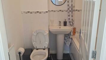 Shower, hair dryer, towels, toilet paper