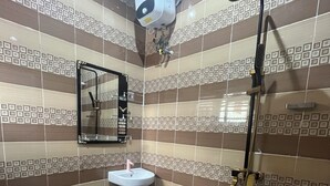 A bathroom with a tiled floor, a sink, a mirror, a shower, and a toilet. - Smart 2-bedroom bungalow in lovely Egbeda with WiFi, AC,parking space,games etc… (Egbeda)