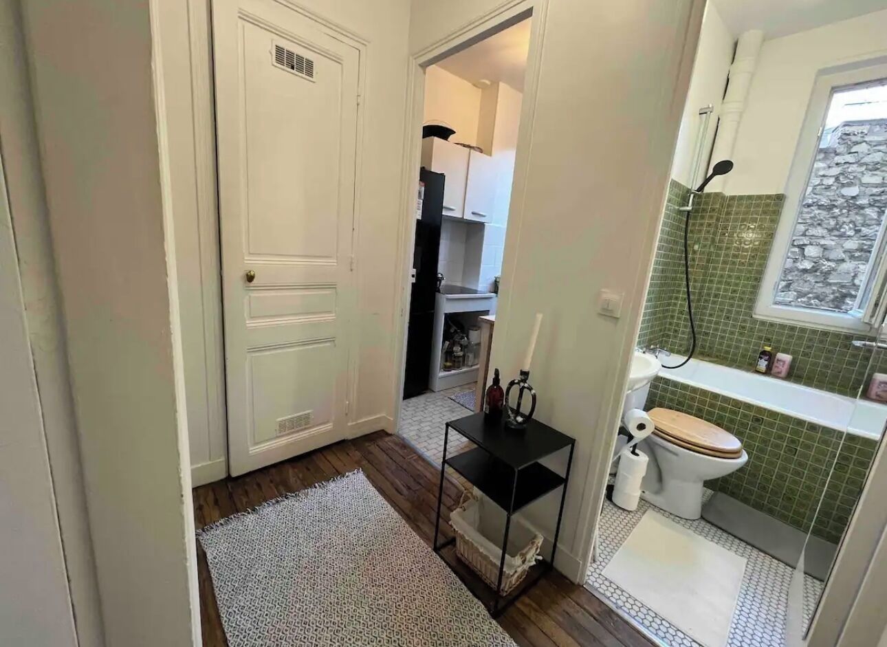A compact bathroom with a toilet, sink, and shower area.