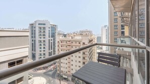 A high-rise building with multiple floors, large windows, and a view of a cityscape. - StayShort - Spacious 2-Bed Al Barsha Escape - Balcony & Modern Amenities, Fits 4 (Al Barsha 1)