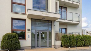 A modern building with a glass entrance, labeled "MODENA 1010" and "Metropolis 2015".
