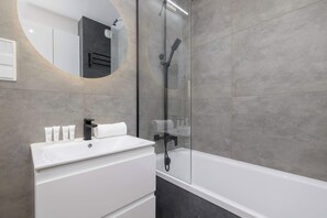 Shower, hair dryer, towels, shampoo