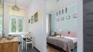 A modern bedroom with a bed, bedside tables, and a window with curtains.