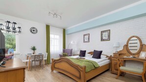 Un dormitorio con una cama de madera, un escritorio, una silla, un aparador, un espejo y un reloj en la pared.