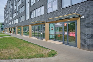 A modern building with large windows and a glass entrance.