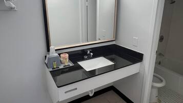 Combined shower/bathtub, towels, soap, shampoo