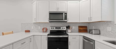 Fridge, coffee/tea maker, paper towels, dining tables