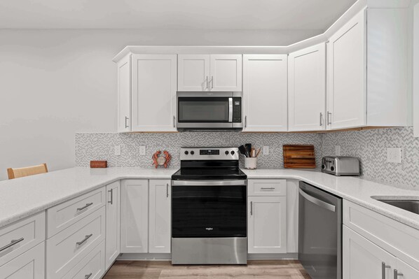 Fridge, coffee/tea maker, paper towels, dining tables