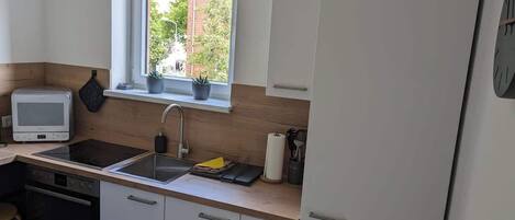 Fridge, stovetop, dishwasher, coffee/tea maker