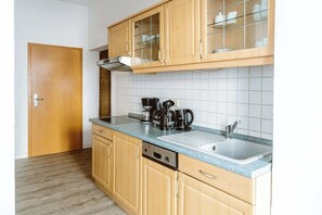 Fridge, stovetop, dishwasher, coffee/tea maker