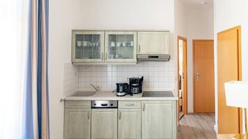 Fridge, stovetop, dishwasher, coffee/tea maker