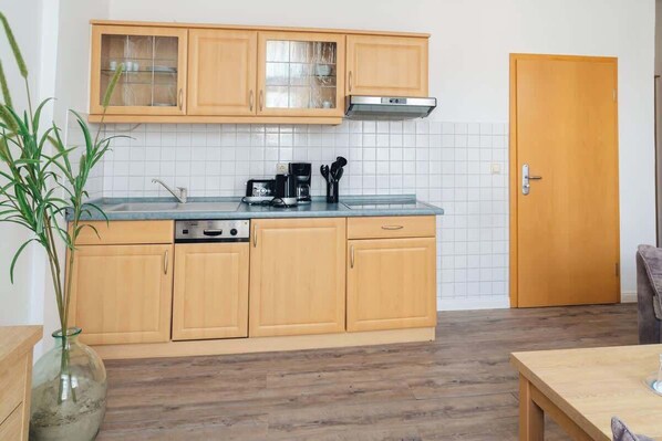 Fridge, stovetop, dishwasher, coffee/tea maker