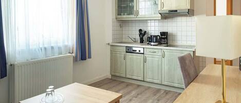 Fridge, stovetop, dishwasher, coffee/tea maker