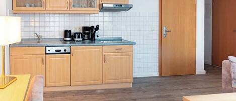 Fridge, stovetop, dishwasher, coffee/tea maker