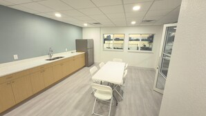 A modern kitchen with a sink, refrigerator, and a view of the city through large windows. - Charming 1-bedroom apartment with WiFi, AC in fabulous Fort Myers Beach. (Fort Myers Beach)
