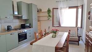 A modern kitchen with a dining area.