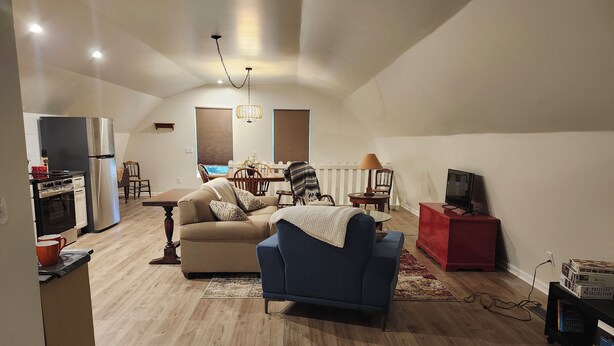 A compact living space with a kitchenette, a sofa, a dining table, and a TV. - Brand new studio apartment with queen bed, queen pull out, WIFI and AC . (Wooster)