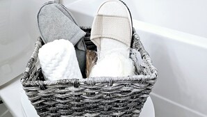 A wicker basket with towels and slippers on a white toilet in a bathroom. - The Luxury Retreat, Calgary

Central location, family oriented, feel at home! (Calgary)