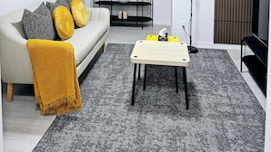 A modern living room with a sofa, coffee table, and a TV stand. - The Luxury Retreat, Calgary

Central location, family oriented, feel at home! (Calgary)