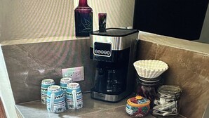 A kitchenette area with a coffee maker, jars, and a decorative item on the counter. - “Serene Courtyard Stay – Follow the Path to the Sea” (Chelem)