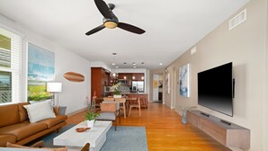 A modern living room with a sofa, coffee table, and TV.