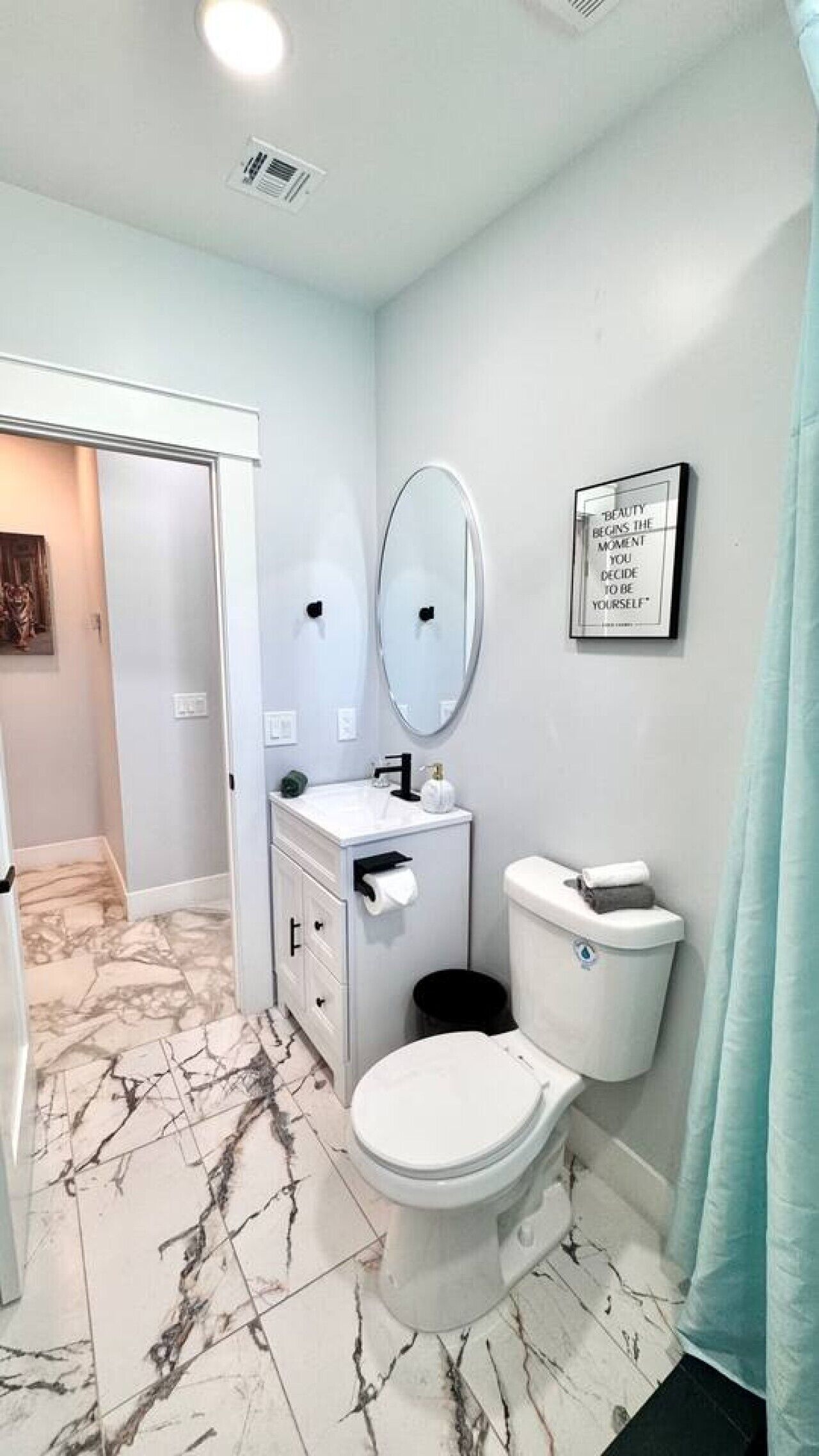 A bathroom with a toilet, bidet, and vanity.