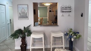 A kitchen with a built-in oven, a sink, and a countertop. There is a potted plant and a vase with flowers on the counter. - Great 2 BR Condo, 7 minutes to Siesta Key (Sarasota)