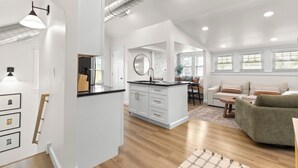 A spacious living area with a kitchen, dining area, and a cozy seating space.