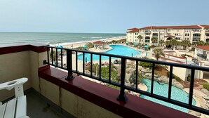 Un hôtel doté d'une piscine, offrant une vue sur la plage et comprenant un bâtiment à plusieurs étages.