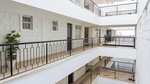 A multi-level residential building with balconies, white walls, and a modern design. - Lux Suites Studio City Apartments (Naivasha)