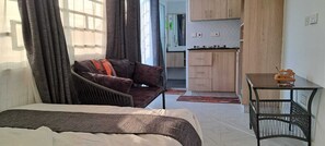 Double Room | Living area | 24-inch Smart TV with digital channels - Lux Suites Wild Wood Cottages Naivasha (Naivasha)