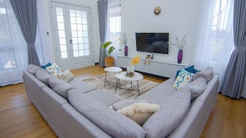 Luxury Bungalow, Garden View | Living area | 32-inch TV with digital channels