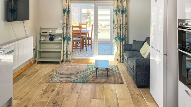 A compact living space with a kitchen, dining area, and seating.