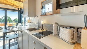 A modern kitchen with a built-in microwave, a sink, and a toaster. - Barn Owl Lodge - UK49903 (Dalton, near Wigan)