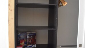 A black metal wardrobe with multiple shelves and drawers, containing books and a small box. - Family home in the heart of the Tarentaise (Moûtiers)