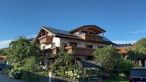 A multi-story building with a sloped roof, wooden balconies, and solar panels. - Vacation apartment Fietz, Gr. Balcony with mountain view 2 bedrooms Parking lot (Anger)