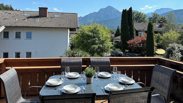 A dining table set outdoors with a mountain view. - Vacation apartment Fietz, Gr. Balcony with mountain view 2 bedrooms Parking lot (Anger)