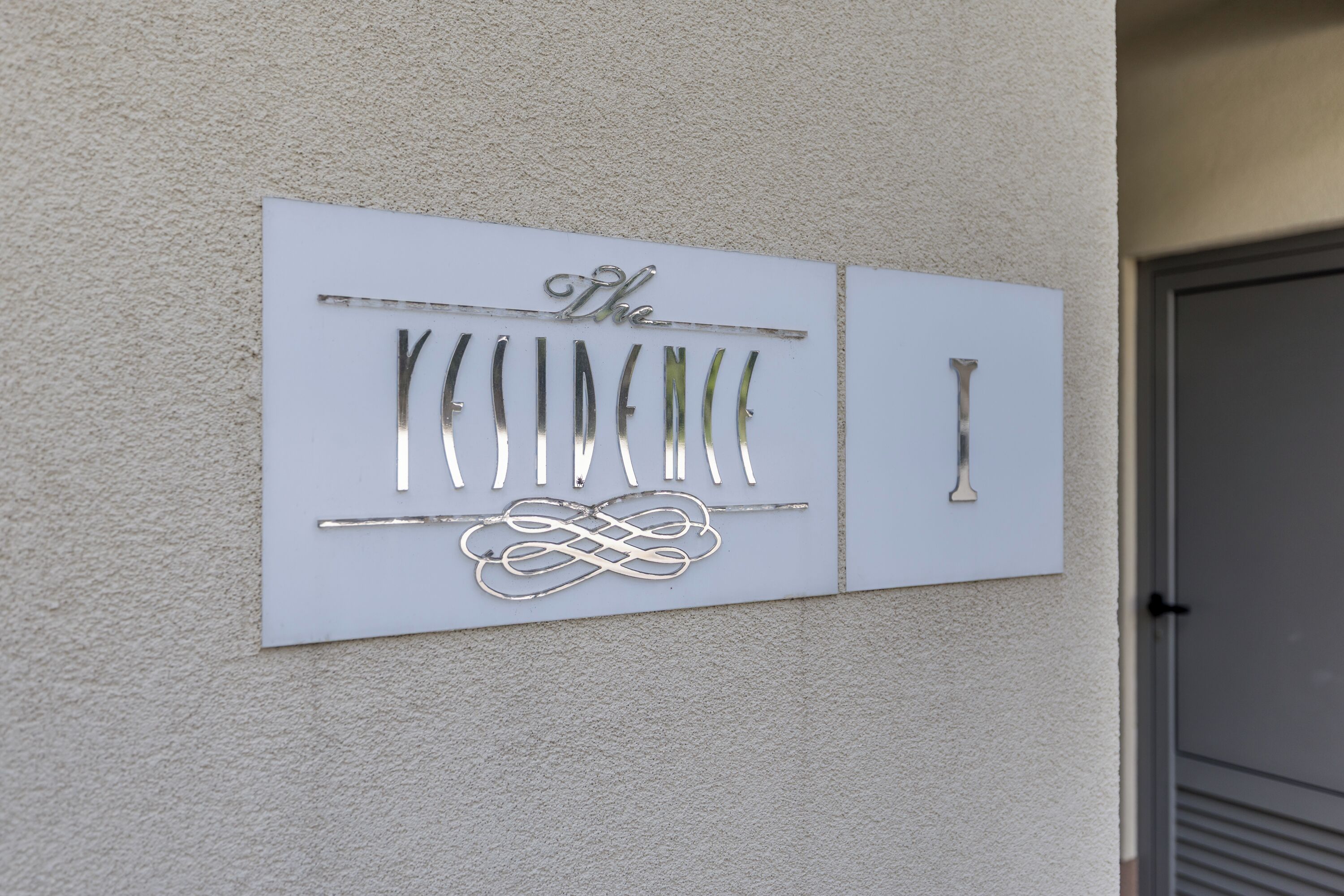 A wall-mounted sign with the text 'The' and a decorative design.