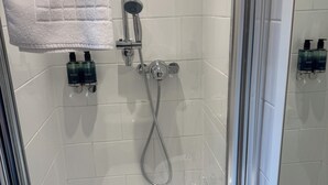 A bathroom with a shower, a toilet, and a sink. - The Law (North Berwick)