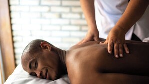 A person receiving a back massage in a room with a brick wall background. - Male Massage therapist for colombo with A/C comfortable room (Colombo)