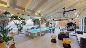 A covered outdoor area with a pool, seating, and a view of the sea. - NIKKON LUXURY LIVING is a luxury private villa, in top of the sea.Enjoy LUXURY. (Viannos)