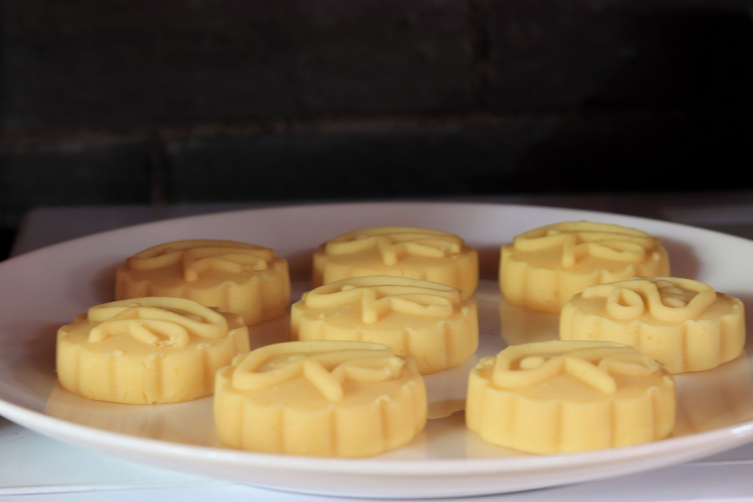 A plate of mooncakes with a decorative pattern on top.