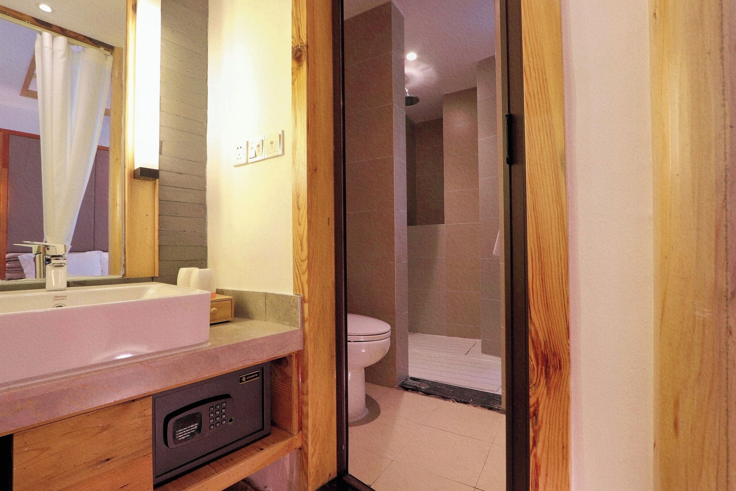 A modern bathroom with a sink, toilet, and shower area.