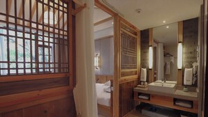 A modern bathroom with a wooden partition, a large mirror, and a sink with a towel rack. - Mild Spring Boutique Hotel (Huangshan)