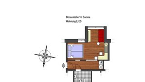 A floor plan of a room with a bed, a small seating area, and a bathroom.