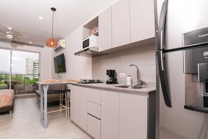 Fridge, microwave, coffee/tea maker, cookware/dishes/utensils