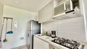 Fridge, microwave, coffee/tea maker, cookware/dishes/utensils