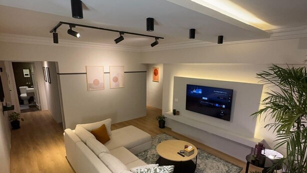 A modern living room with a sofa, coffee table, and TV. - The Ground-floor Gem - Zahraa Al Maadi (Cairo Governorate)