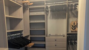 A walk-in closet with open shelving, drawers, and hanging space. - Walkable Ocean-View Lantern District Home with AC & Garage (Dana Point)