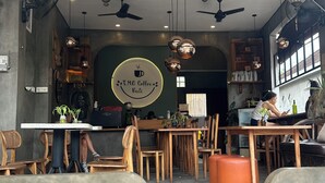 A cozy cafe with wooden furniture, ceiling fans, and pendant lights. - Vibey, spacious 3-bedroom villa with WiFi, AC, Pool, in the heart of Canggu (Canggu, Kec.Kuta Utara, Kab. Badung)